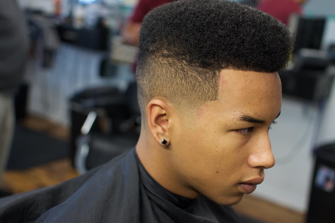 Young man with a fresh skin fade in the barber chair